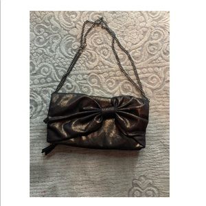Gap Bronze Fold-over Clutch with Bow Detail and Metal Strap
